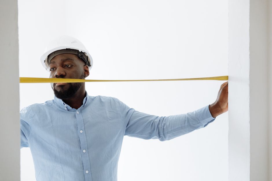 Friendly home contractor fitting a door